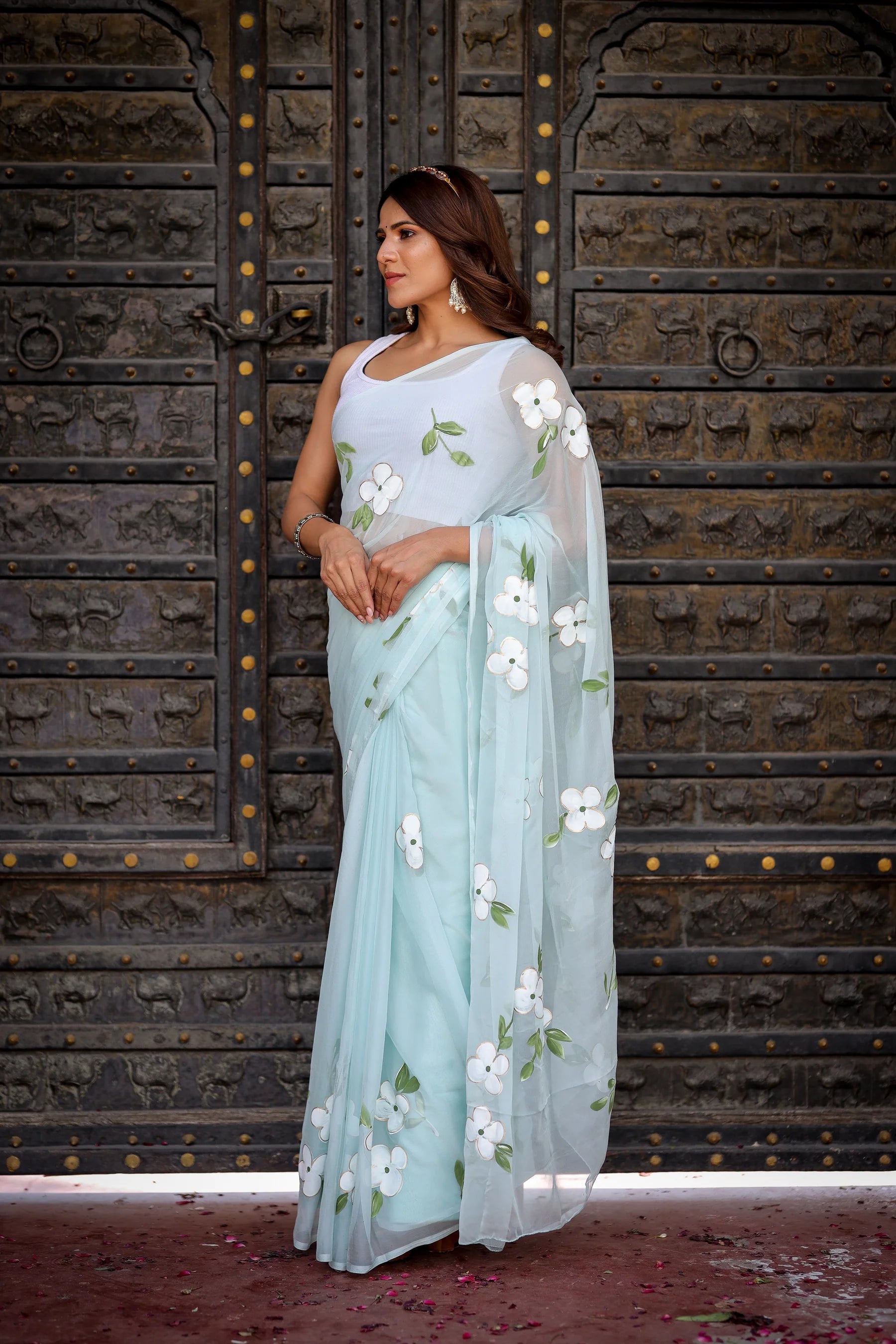 Pastel Blue Georgette Saree with Hand-Painted White Floral Motifs & Green Leaves – Attached Blouse – 5.5 Meters