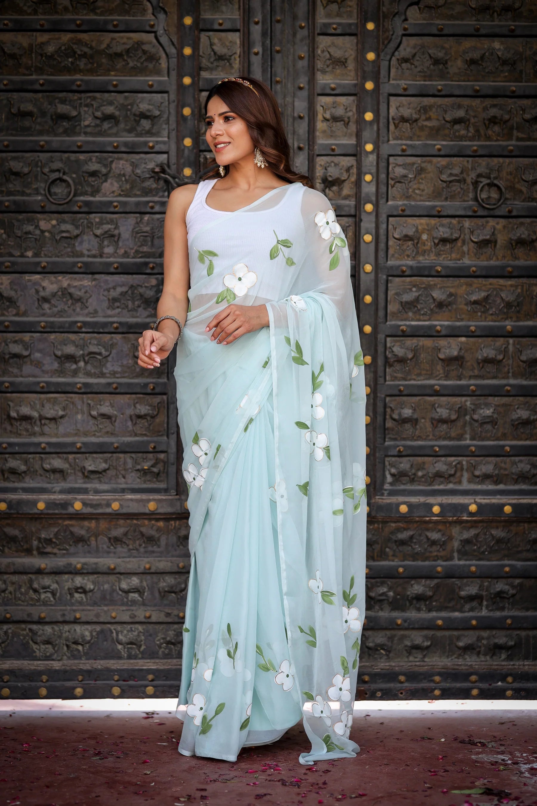 Pastel Blue Georgette Saree with Hand-Painted White Floral Motifs & Green Leaves – Attached Blouse – 5.5 Meters