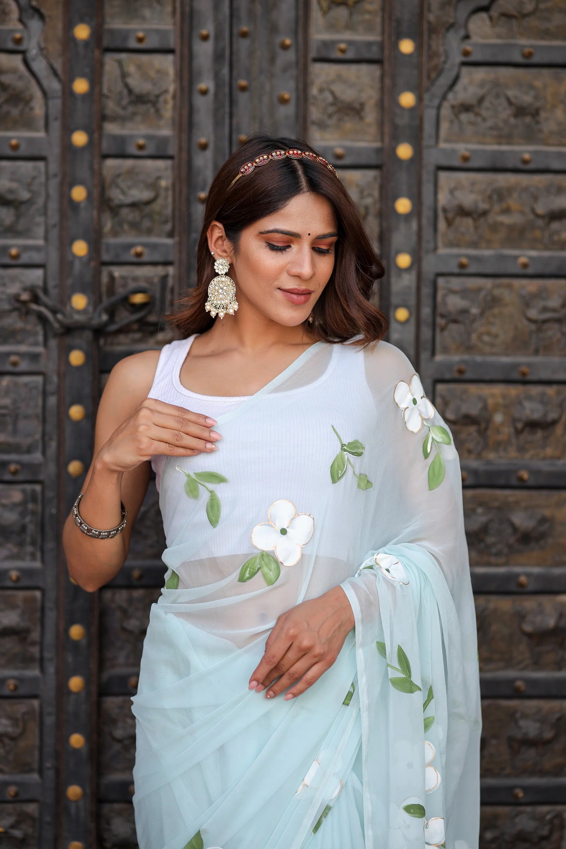 Pastel Blue Georgette Saree with Hand-Painted White Floral Motifs & Green Leaves – Attached Blouse – 5.5 Meters