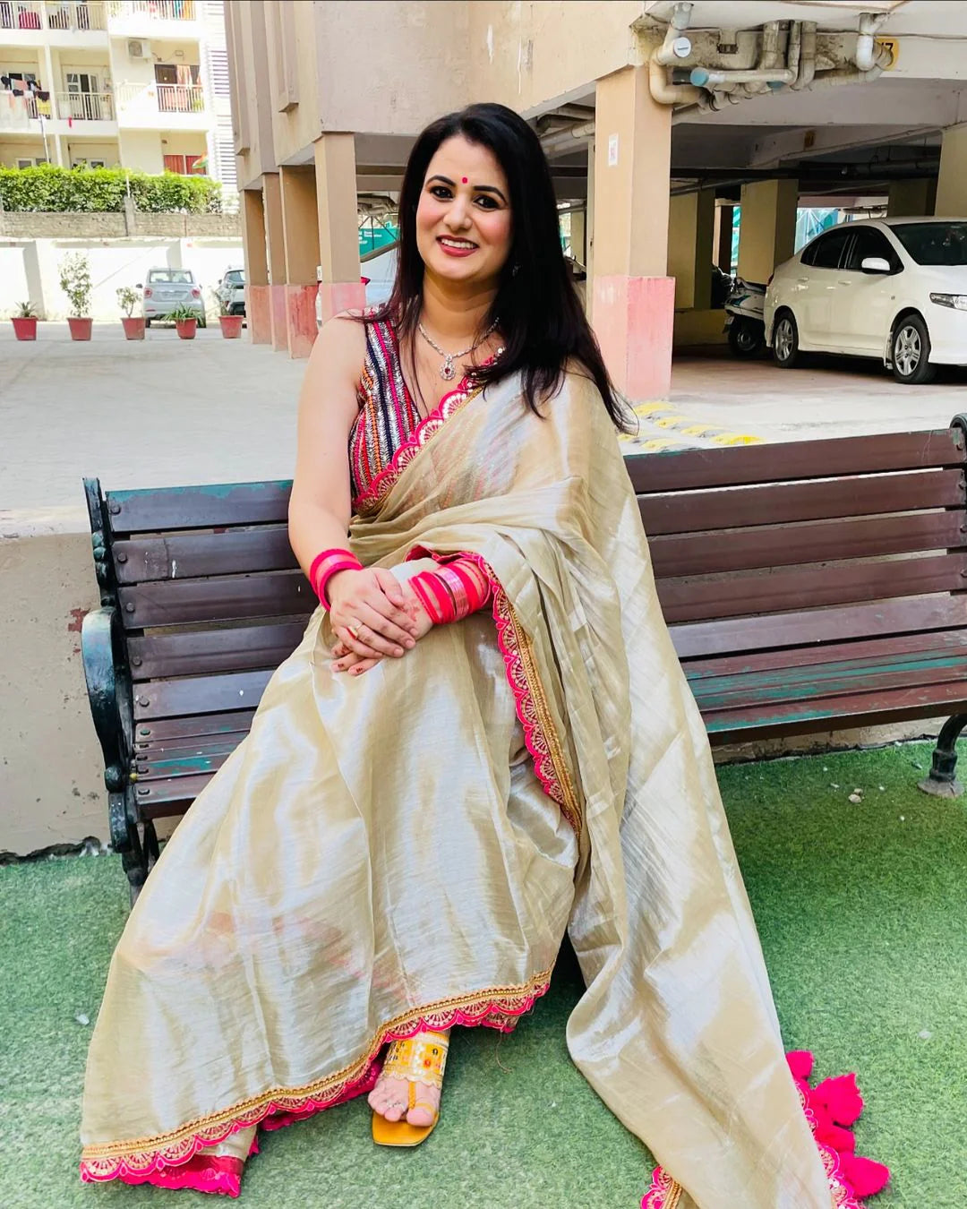 Classy Gold and Pink Saree with Glossy Finish and Tassel Accents